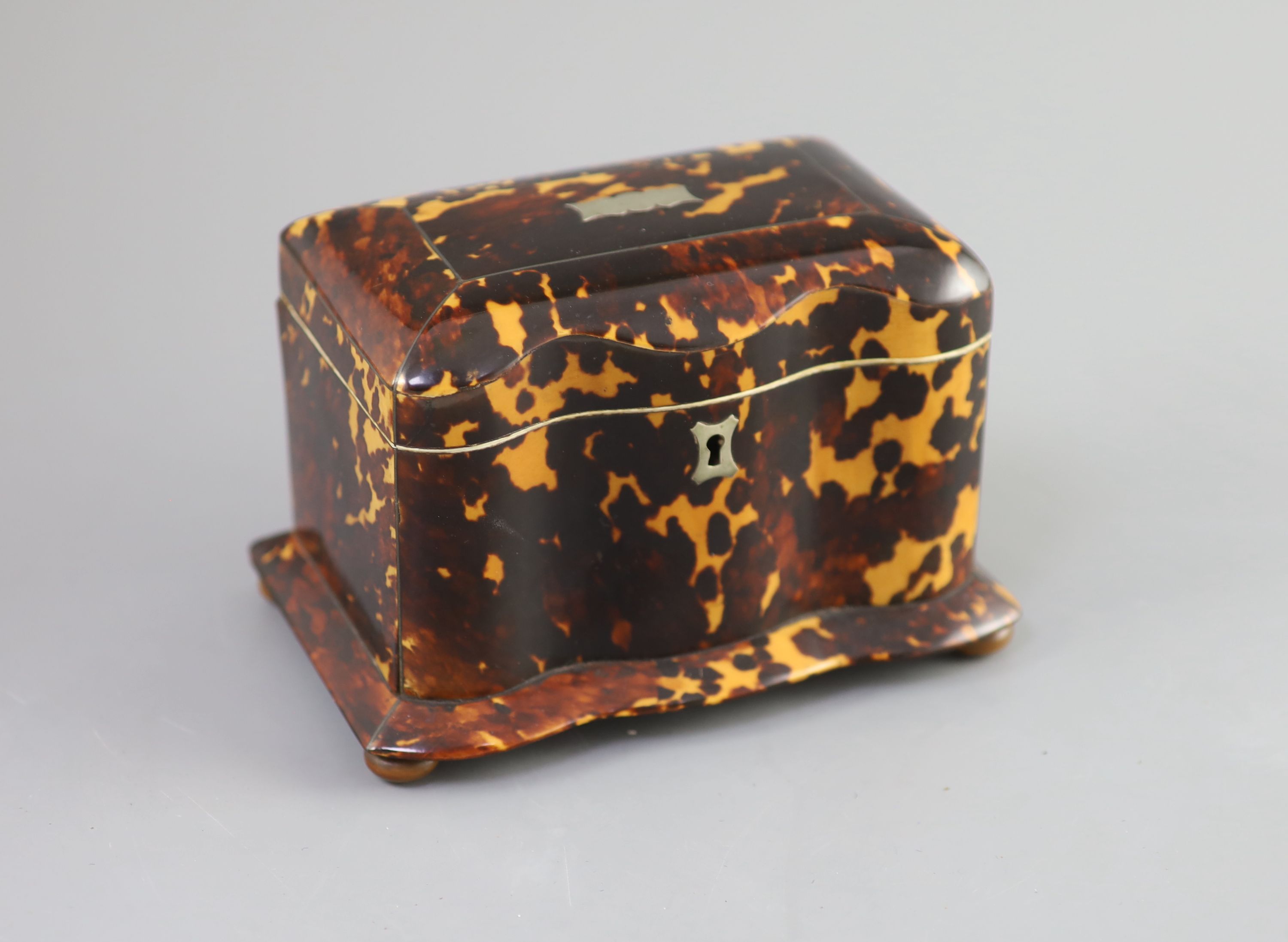 A 19th century tortoiseshell tea caddy, 18cm wide, 11cm deep, 11.5cm high.